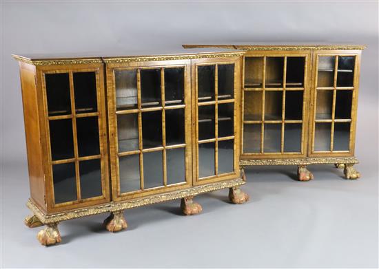 A pair of early 20th century feather banded walnut breakfront dwarf bookcases, W.4ft 8in. D.1ft 4in. H.3ft 5in.